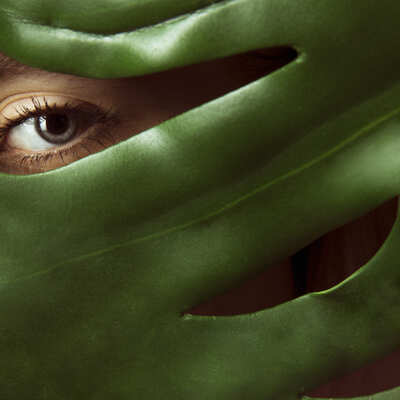 woman-covering-face-with-green-l